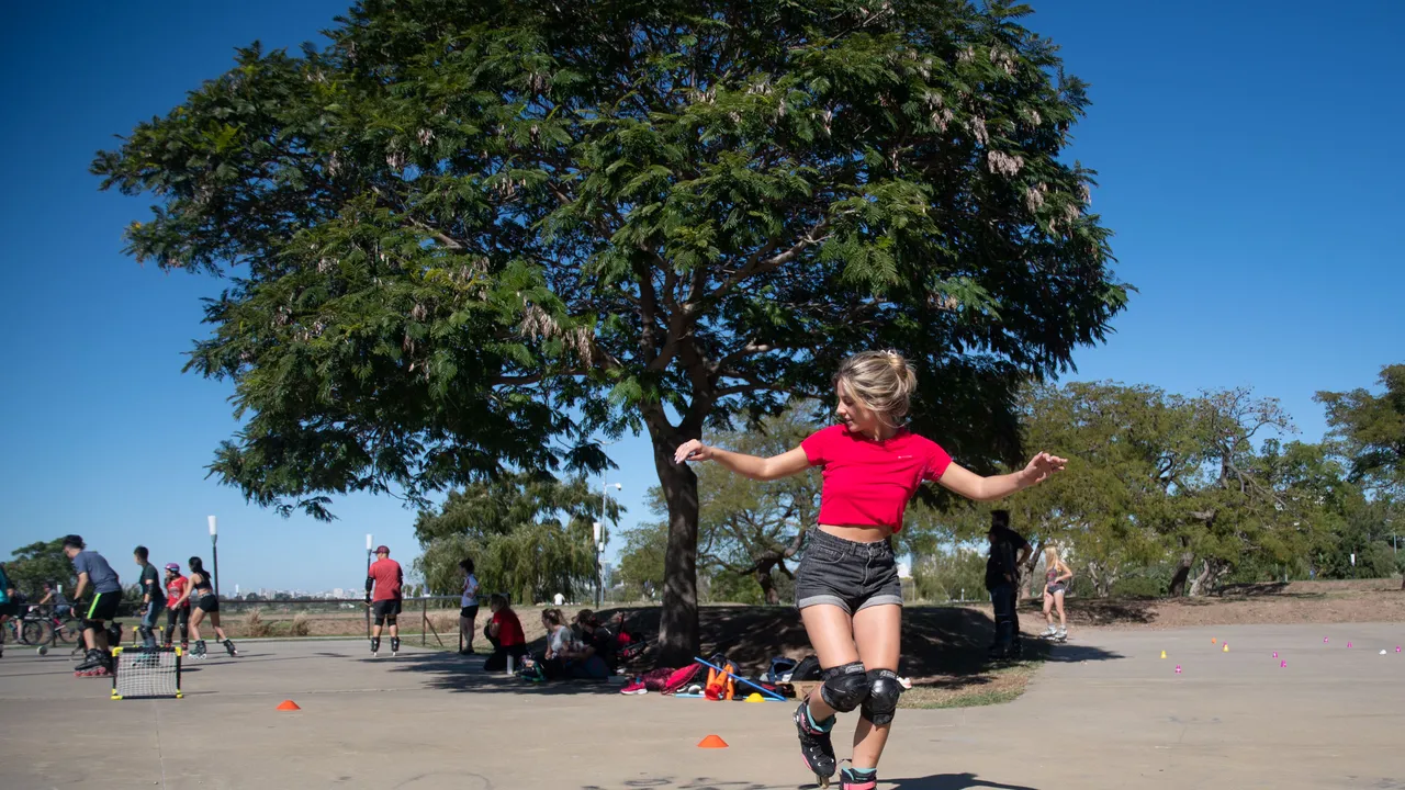 Patinadora con los brazos abiertos manteniendo el equilibrio sobre rollers
